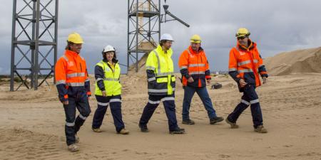 Staff in high vis walking outside