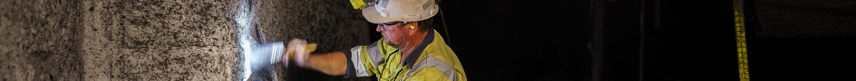 Underground mine worker using brush