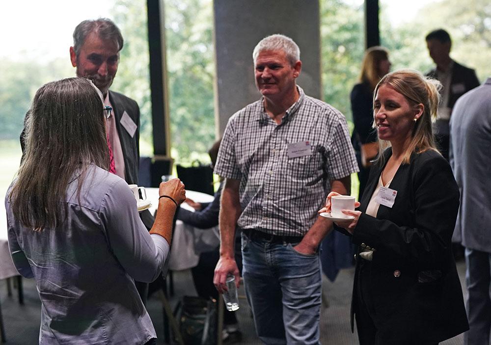 Exploration in the House 2025 attendees talking during a break
