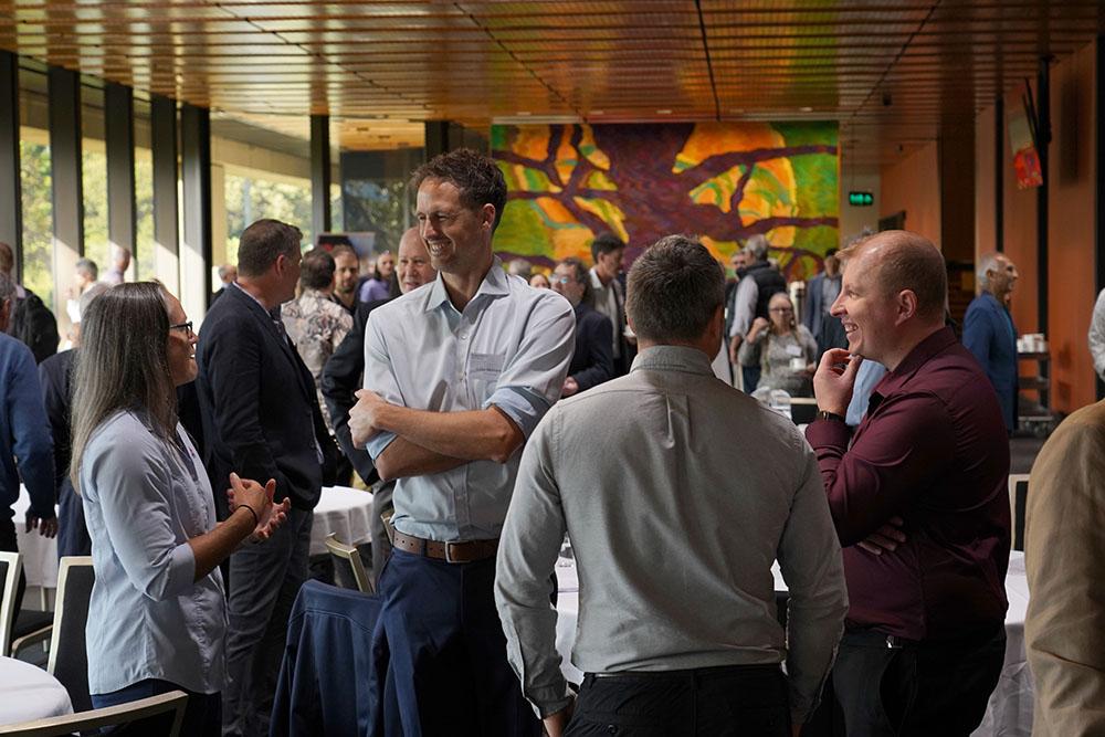 Exploration in the House 2025 attendees talking during a break
